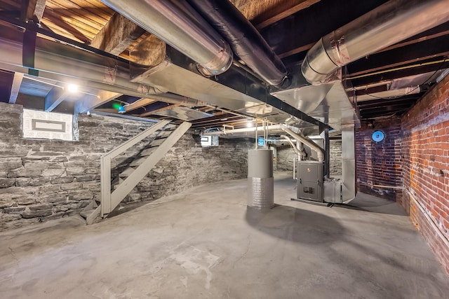 basement featuring water heater and heating unit