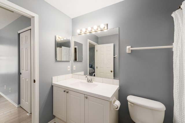 bathroom with vanity, hardwood / wood-style floors, and toilet