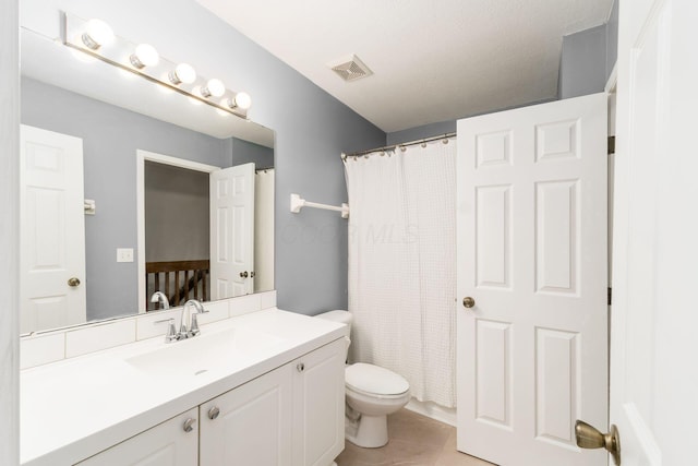 bathroom featuring vanity, curtained shower, tile patterned floors, and toilet