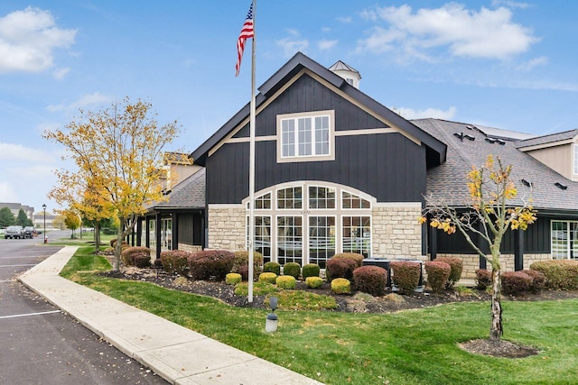 view of side of property with a yard