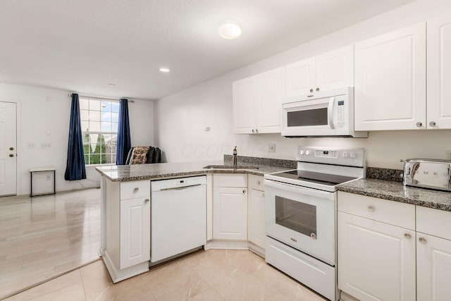 7083 Gallant Fox Dr Unit 4, New Albany, OH 43054 - kitchen featuring white appliances, a peninsula, a sink, white cabinetry, and recessed lighting