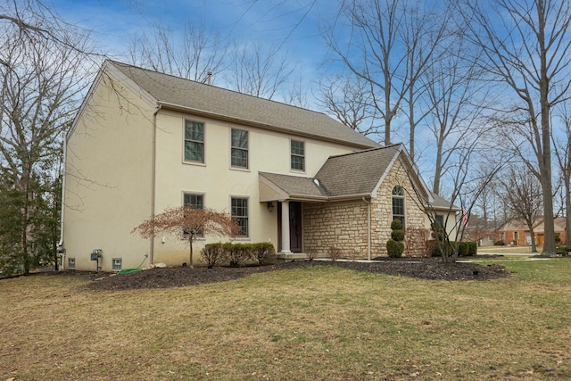 view of front of home featuring a front yard, stone siding, roof with shingles, and stucco siding