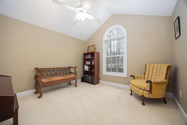 living area with a ceiling fan, baseboards, visible vents, carpet floors, and lofted ceiling