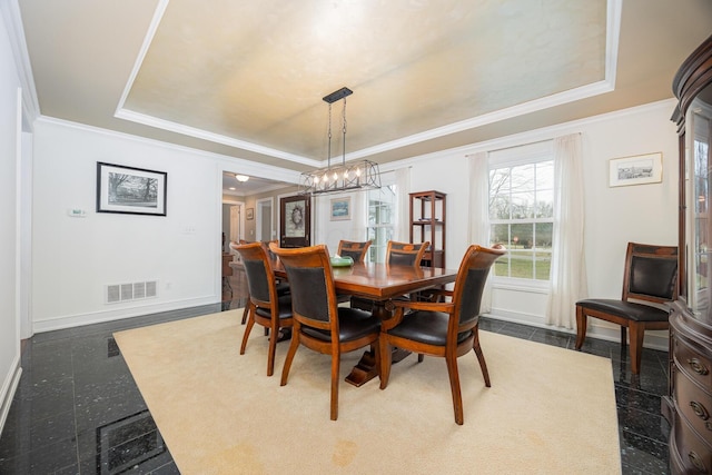 dining space featuring visible vents, baseboards, a tray ceiling, granite finish floor, and crown molding