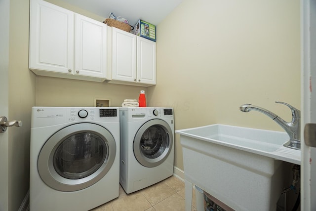 washroom with light tile patterned floors, cabinet space, and independent washer and dryer