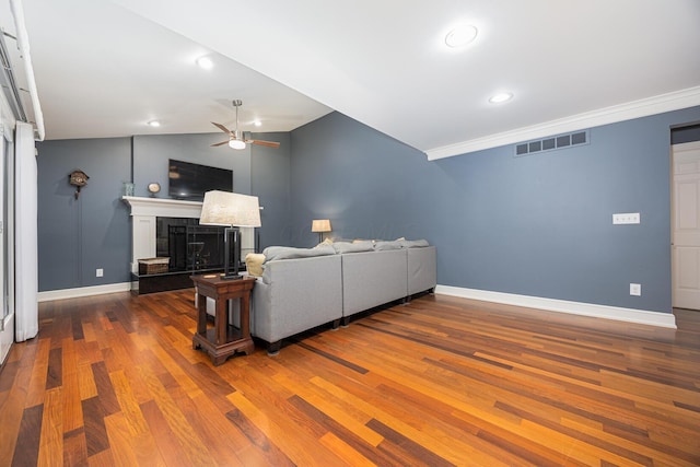 living room featuring wood finished floors, visible vents, and baseboards