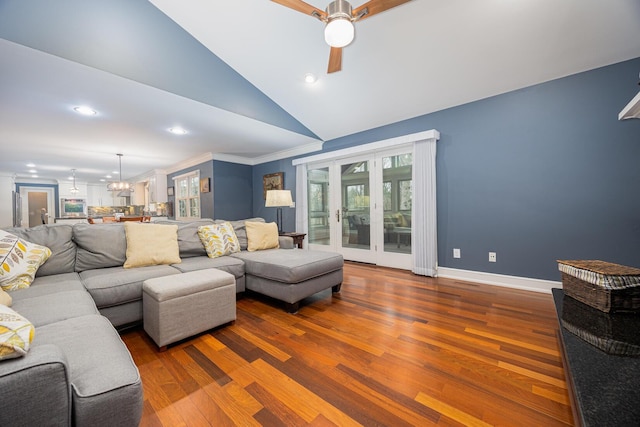 living room with wood finished floors, french doors, lofted ceiling, and ornamental molding