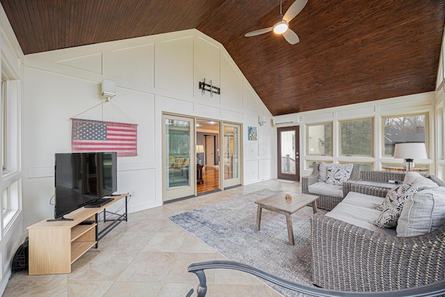 living area featuring wood ceiling, a wall mounted AC, and a decorative wall