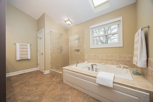 full bathroom with visible vents, a garden tub, a skylight, a shower stall, and baseboards