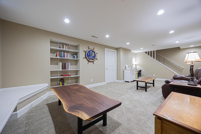 carpeted living area with visible vents, built in shelves, baseboards, stairs, and recessed lighting