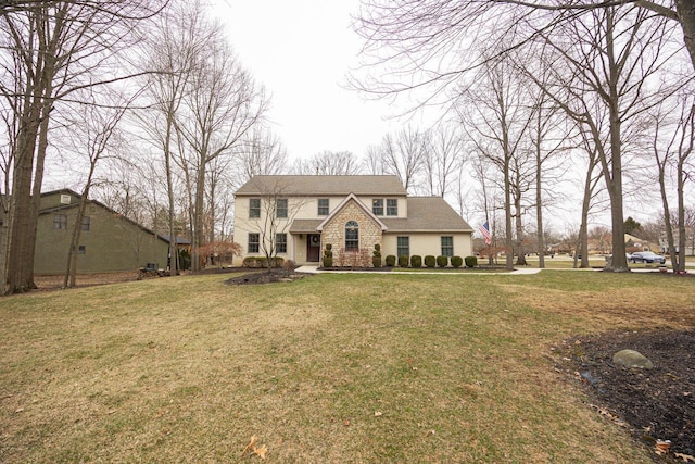 view of front of home with stone siding and a front yard