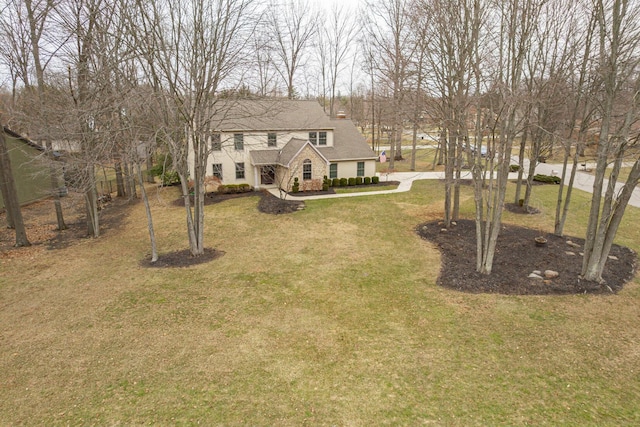 view of front of house featuring stone siding and a front yard