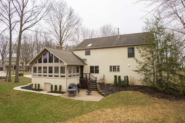 back of house with stucco siding, a lawn, a chimney, a sunroom, and a patio area