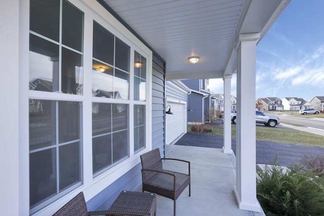 view of patio / terrace with a garage and covered porch