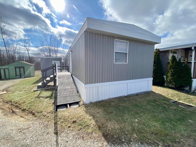 view of home's exterior with a storage shed and a lawn