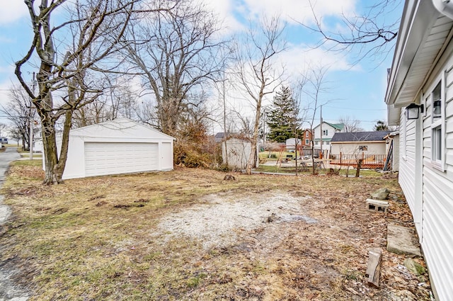 view of yard featuring a garage and an outdoor structure