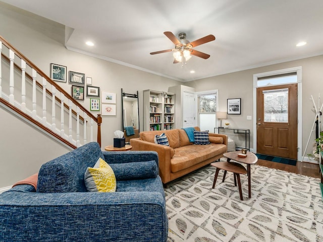 living room featuring ornamental molding, ceiling fan, and light hardwood / wood-style floors