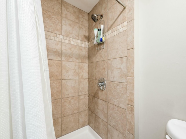 bathroom with a shower with curtain and toilet