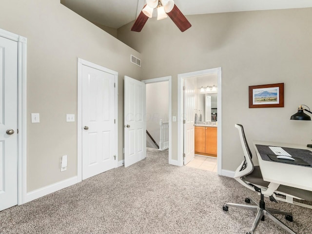 carpeted office space with high vaulted ceiling and ceiling fan