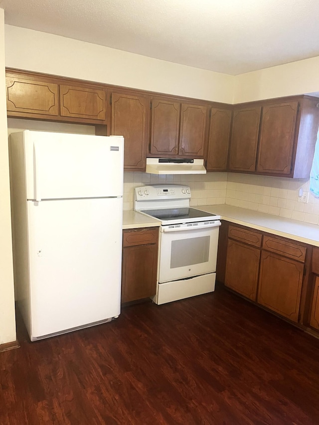 kitchen featuring white appliances, dark hardwood / wood-style floors, and decorative backsplash