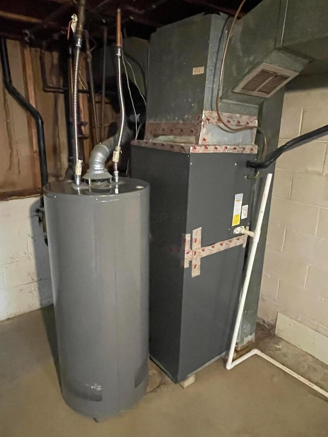 utility room featuring gas water heater