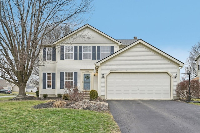 view of front of home with a garage and a front yard