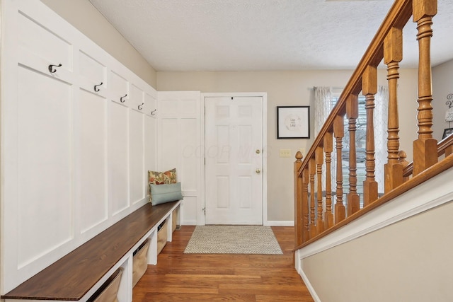 mudroom with hardwood / wood-style floors and a textured ceiling