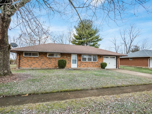 ranch-style home with a garage and a front lawn