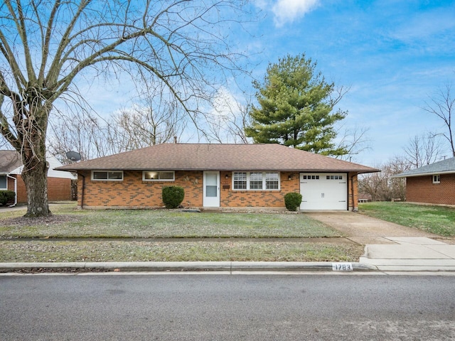 ranch-style house with a garage and a front yard