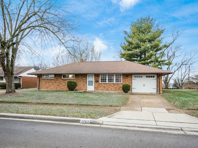 ranch-style home with a garage and a front lawn