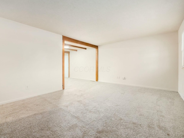 carpeted spare room featuring a textured ceiling