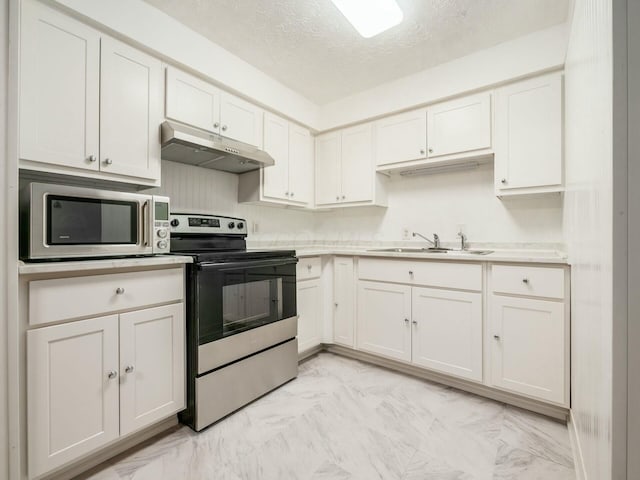 kitchen featuring white cabinetry, appliances with stainless steel finishes, sink, and a textured ceiling