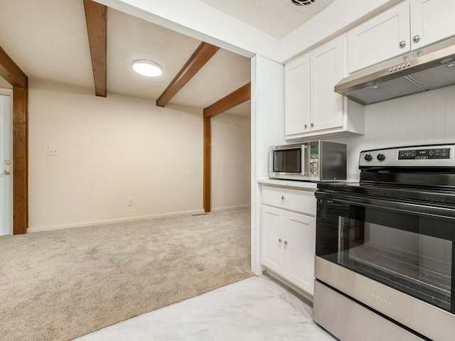 kitchen featuring light colored carpet, beamed ceiling, stainless steel appliances, and white cabinets