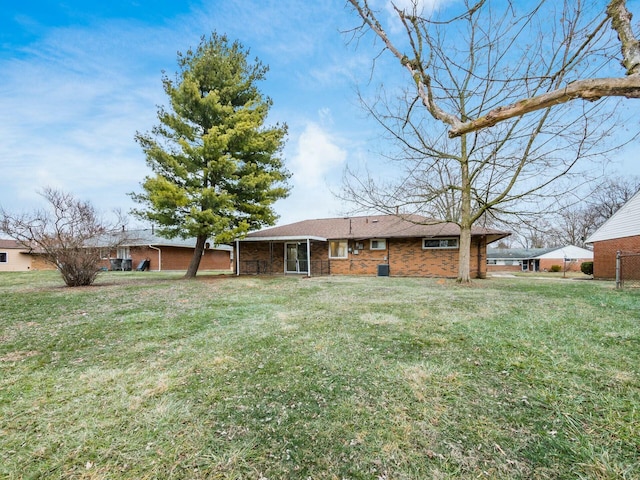 back of house featuring a lawn