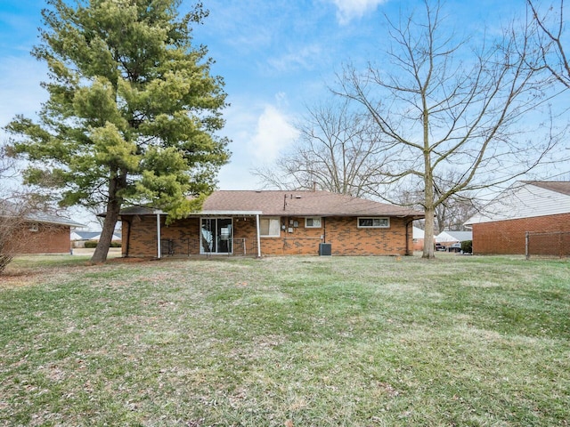 back of house featuring a yard