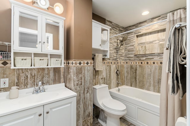 full bathroom featuring vanity, shower / bath combo, tile walls, and toilet