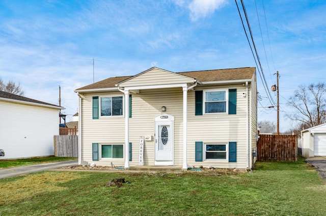 split foyer home featuring a garage and a front lawn