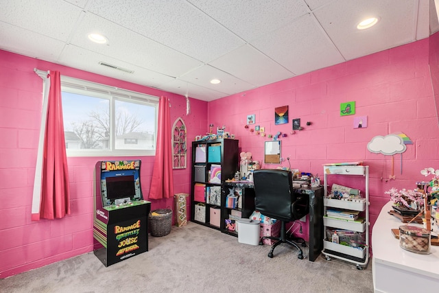 carpeted home office featuring a paneled ceiling