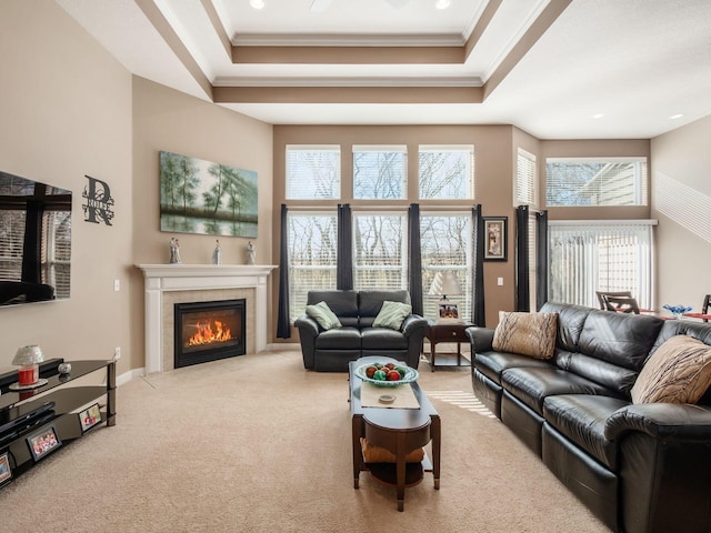 living room with crown molding, a tray ceiling, and carpet floors