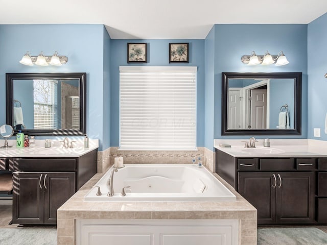 bathroom with vanity and tiled bath