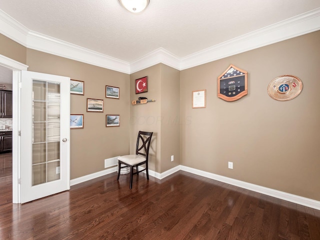 unfurnished room with crown molding, wood-type flooring, and a textured ceiling