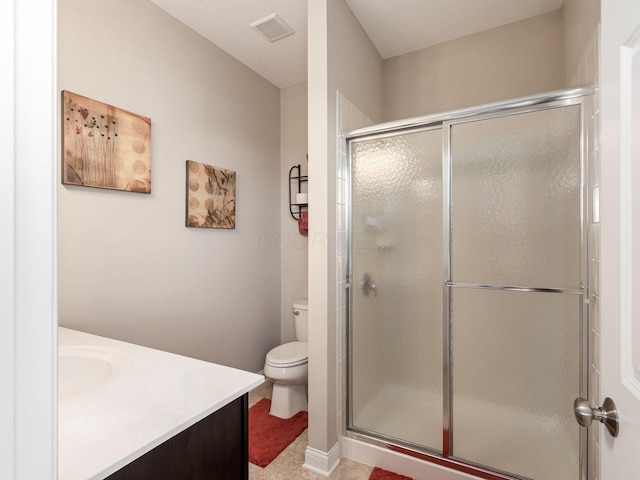 bathroom featuring vanity, toilet, and walk in shower