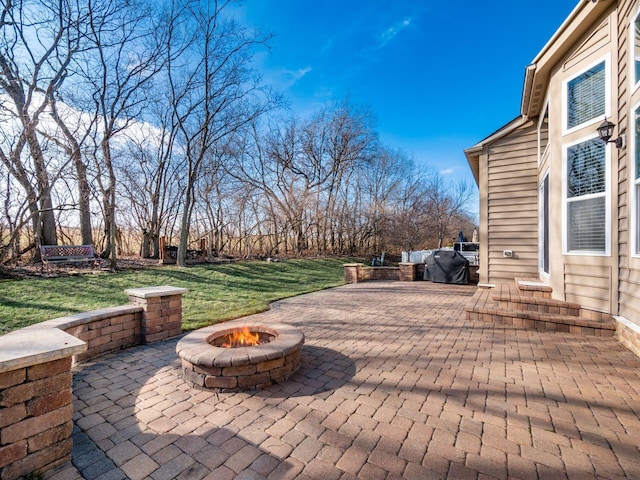 view of patio featuring a grill and a fire pit