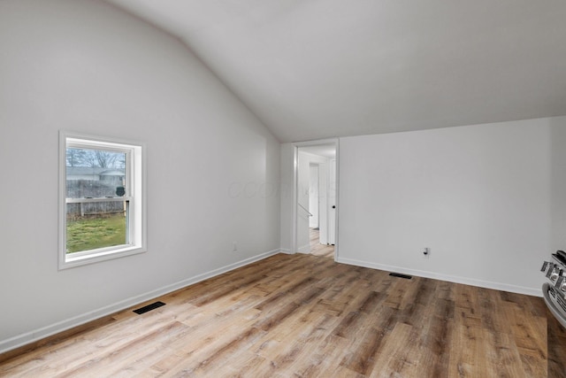 interior space featuring light hardwood / wood-style floors and vaulted ceiling