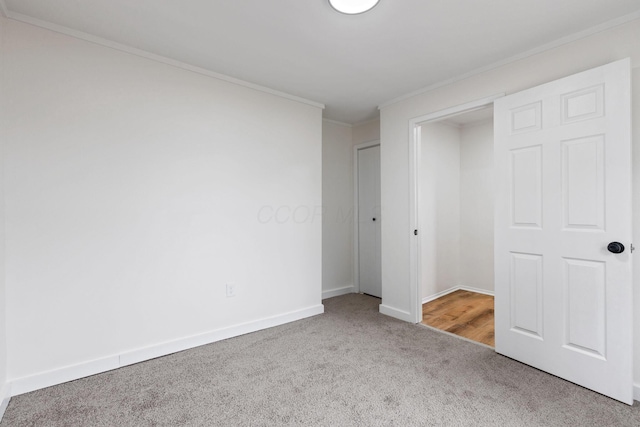 unfurnished bedroom with crown molding and carpet floors