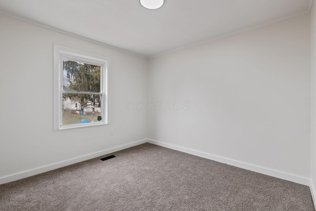 carpeted empty room featuring ornamental molding