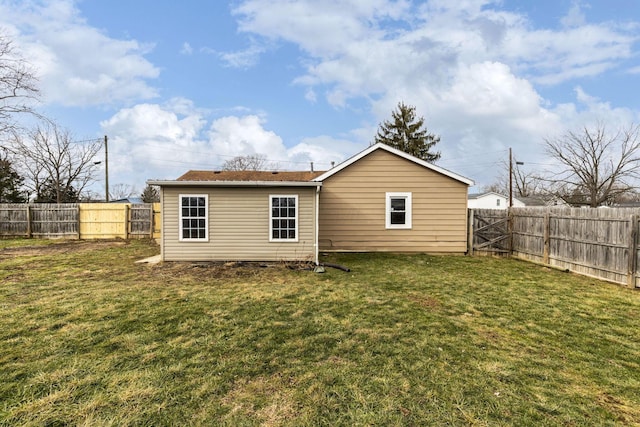 rear view of property with a yard