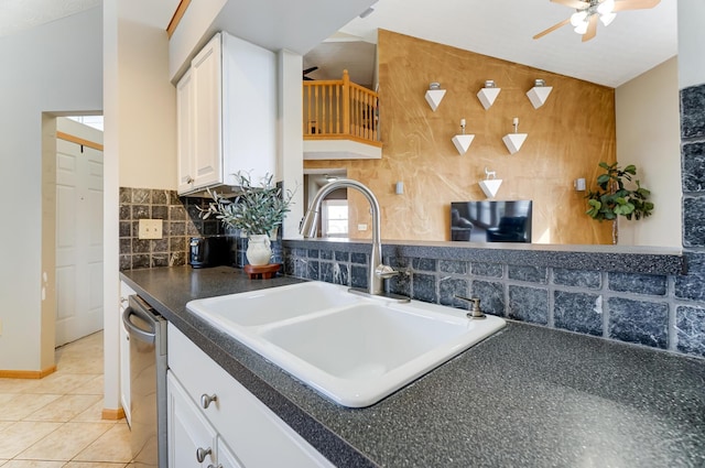 kitchen featuring sink, light tile patterned floors, dishwasher, white cabinets, and backsplash