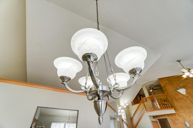 room details with ceiling fan with notable chandelier