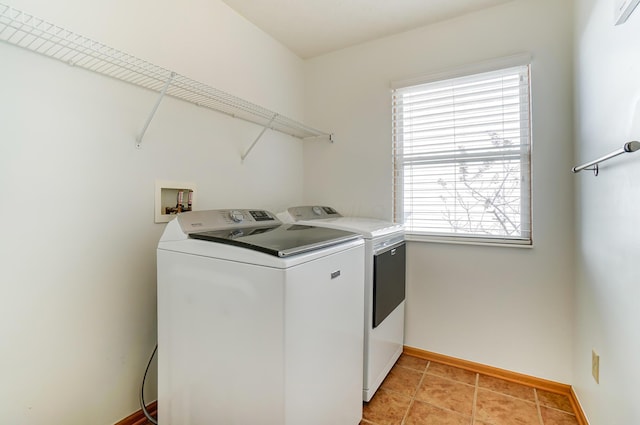 laundry room with separate washer and dryer and light tile patterned floors